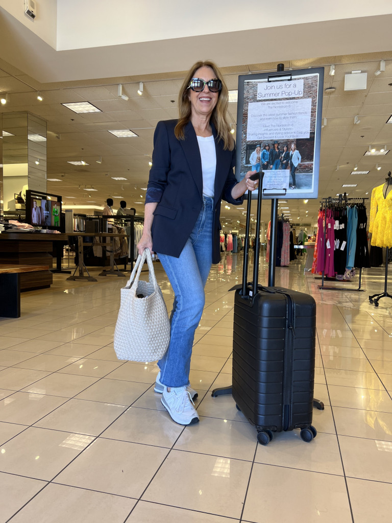 Travel outfit. Blazer, white tee, jeans, sneakers, naghedi tote and away suitcase