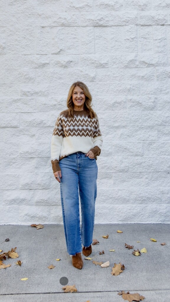 Nuetral camel and white Fair Aisle Sweater, cropped wide-leg jeans and brown boots. On black friday sales.
