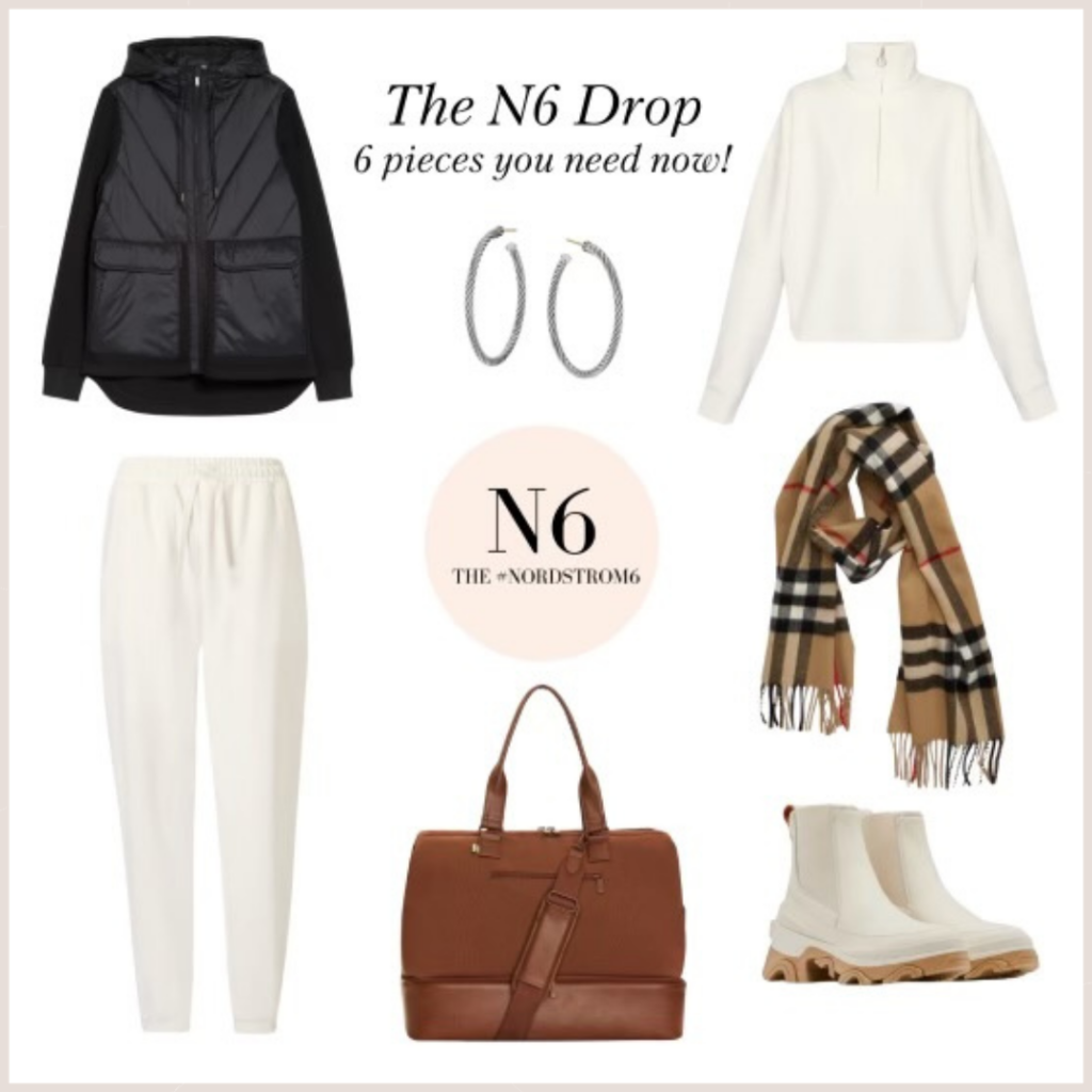 The December N6 Drop. It includes a black, hooded knit and nylon jacket, Silver hoop earrings, a Burberry plaid scarf, White half zip pullover and matching joggers, white winter boots and a whiskey color weekender bag.