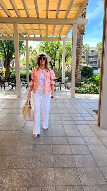 Coral pink coat with ecru jeans.