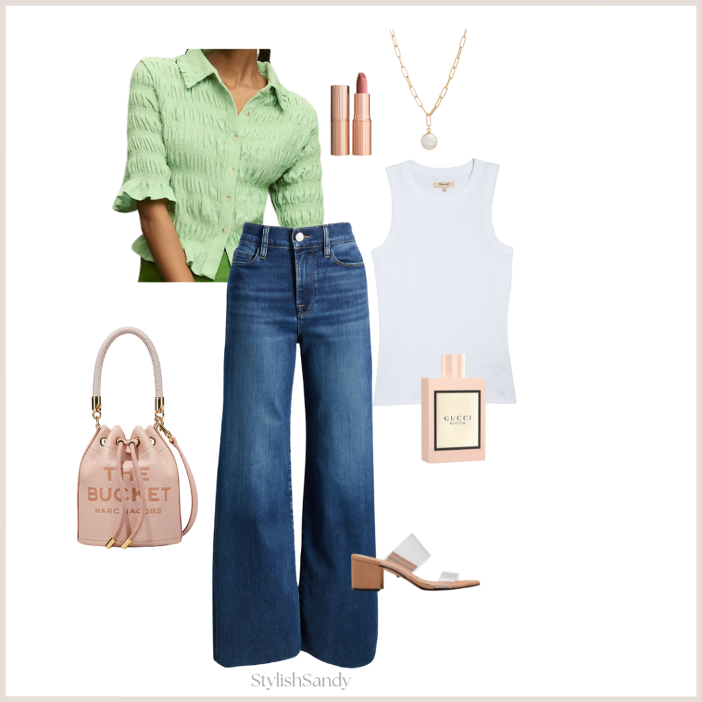 Spring outfit wearing wide-leg jeans, green sweater, bucket bag, sandals, tank, fragrance, and lipstick.