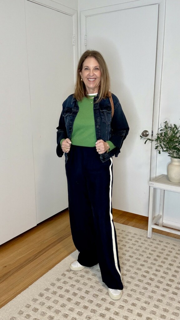 track pants styled with a monochromatic jacket and green sweater