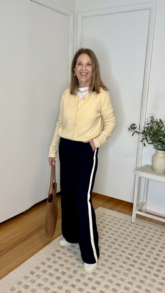 track pants styled with a yellow cardigan